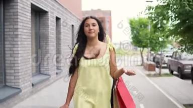 穿着长裙的年轻女孩购物后心情愉快地<strong>环游</strong>城市。 4K